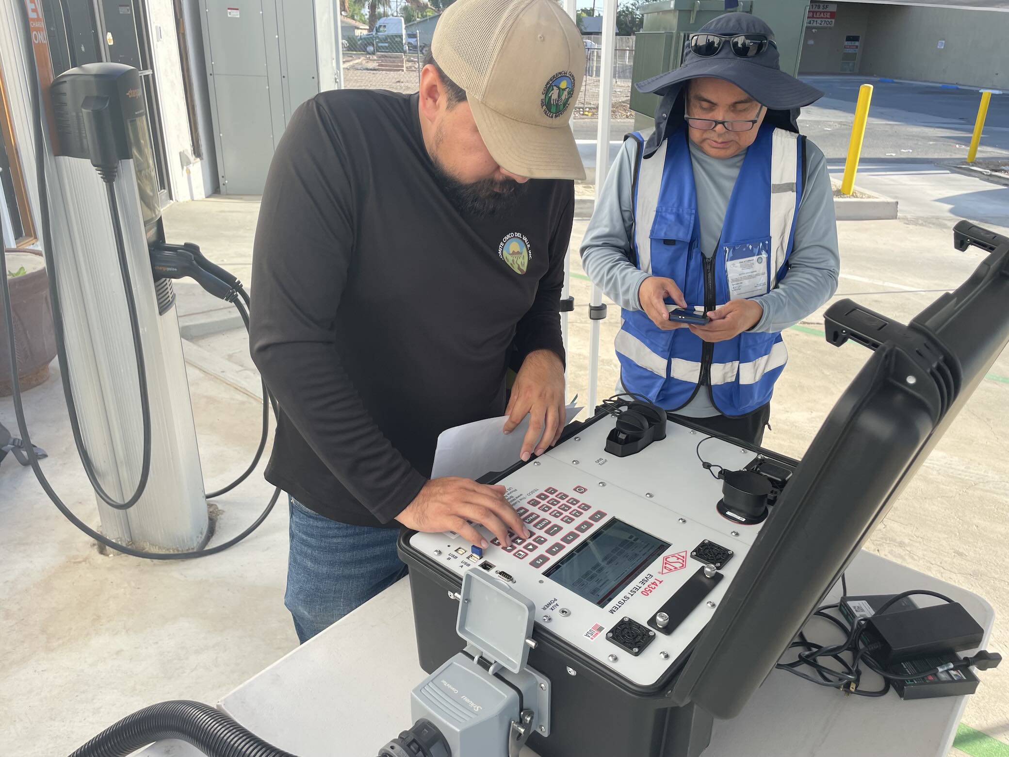 Technicians testing an EV charging station